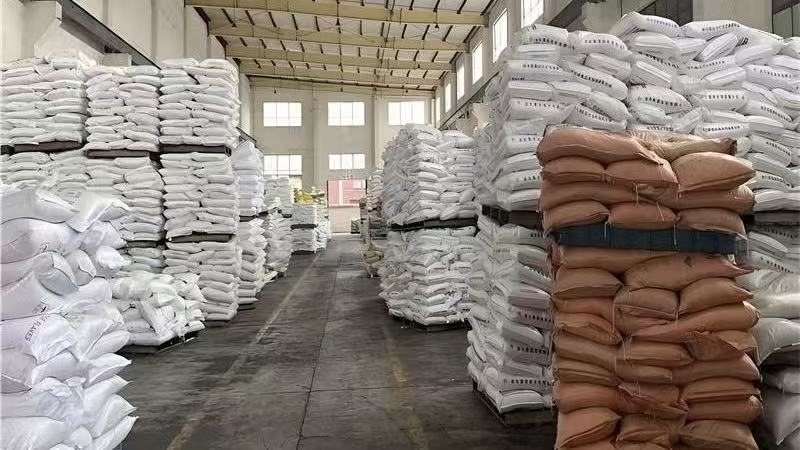 Bagged caustic soda flakes stacked in the plant warehouse